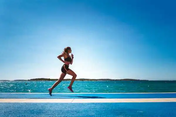 Woman running showing strong leg muscle Oxted